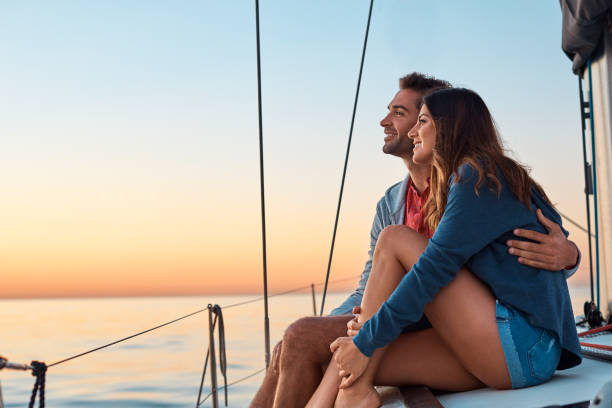 Shot of a young couple enjoying a cruise out on the ocean